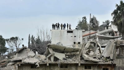 Residents survey the damage after returning to the southern Lebanese border village of Odaisseh after Israeli troops pulled out. AFP