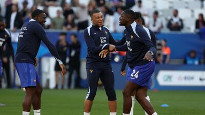 Kylian Mbappe jokes with Ibrahima Konate during the warm-up ahead of the match between France and Canada. AFP