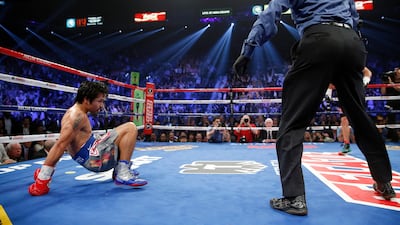 Manny Pacquiao, from the Philippines, lifts himself from the canvas as referee Kenny Bayless stands by after being knocked down in the third round of his WBO world welterweight fight against Juan Manuel Marquez, from Mexico, Saturday, Dec. 8, 2012, in Las Vegas. (AP Photo/Eric Jamison) *** Local Caption *** Pacquiao Marquez Boxing.JPEG-05afa.jpg