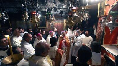 Clergy pray in the 'Grotto', where Christians believe the Virgin Mary gave birth to Jesus Christ, in the Church of the Nativity, in the West Bank town of Bethlehem.