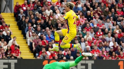 Conor Gallagher leaps over Liverpool goalkeeper Alisson. AP