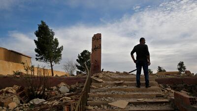 Zaya Youkhana, an Assyrian Christian stands on the rubble of a destroyed church that blown up by Islamic State militants in 2015 with Arabic that reads, "Worshippers of the cross," in the deserted village of Tal Jazeera, northern Syria. The Qatar-based Syrian Network for Human Rights, a Syrian war monitor associated with the opposition said in its report that over 120 Christian places of worship have been damaged or destroyed by all sides in the country’s eight-year conflict. AP