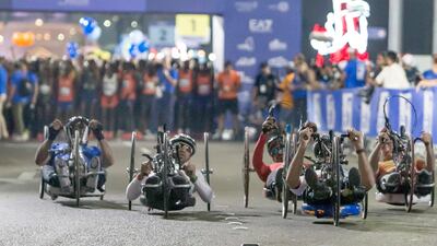 Paraathletes in a wheelchair participating in the marathon at the Adnoc Abu Dhabi Marathon. Leslie Pableo for The National