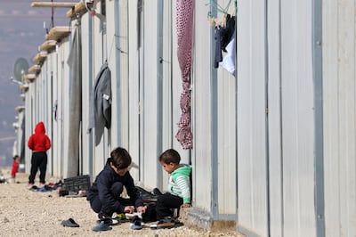 Refugee children play outside makeshift shelters at the Imam Ali Complex in Hermel, Bekaa Valley, near the border with Syria. EPA