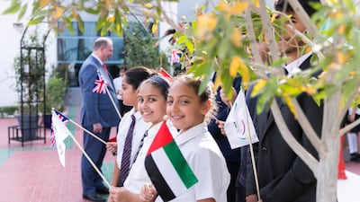 Students await the arrival of Prince Edward.