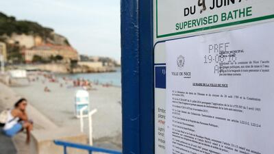 This picture shows the bylaw forbidding women to wear burqinis on the beach in Nice. Jean Christophe Magnenet / AFP