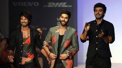 Lakme Fashion Week's star power included, from left, Shahid Kapoor, the designer Kunal Rawal and Arjun Kapoor. PUNIT PARANJPE / AFP