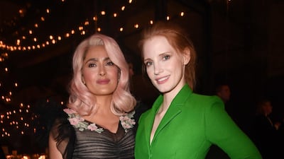 Salma Hayek and Jessica Chastain, in a green Christian Dior shirt dress, attend the Women in Motion Awards Dinner at the 70th Cannes Film Festival at Place de la Castre on May 21, 2017. Getty Images
