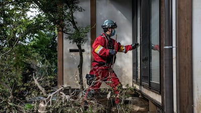 A rescue worker checks a property after heavy flooding caused by Typhoon Hagibis in Hoyasu near Nagano, Japan. Japan has mobilised over 100,000 rescue workers after Typhoon Hagibis, the most powerful storm in decades, swept across the country killing 66 people and leaving thousands injured and homeless. Getty Images