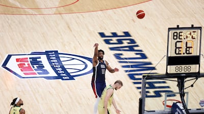 Joel Embiid of USA scores during the game against Australia.