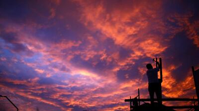 A man at work during sunset in Santiago, Chile. Ivan Alvarado / Reuters