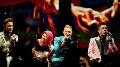 She was invited on stage by the Irish band after they noticed her sign.