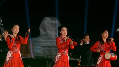 The musicians' bold red outfits stood out against the night sky. AP