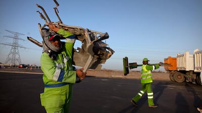 Workers clean up the remnants of a tragic traffic accident. Silvia Razgova / The National