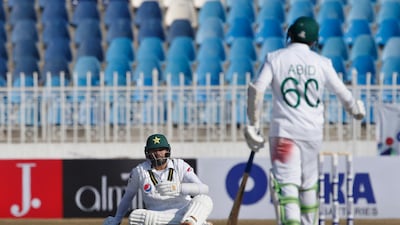 Pakistan's Azhar Ali, centre, loses his balance as teammate Abid Ali looks on in the Rawalpindi Test against Sri Lanka on Sunday. AP
