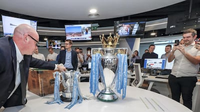 The Premier League trophy and Carabao Cup visit The National newsroom.