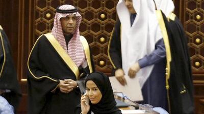 A female member of the Saudi Arabian Shura Council speaks on the phone as she attends a session chaired by Saudi Arabia's King Salman in Riyadh on December 23. Faisal Al Nasser / Reuters