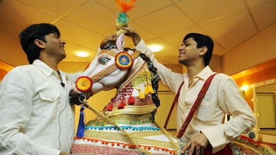 Sayed Faisal (on left) and Neeraj Ruparel (on right), wardrobe props managers, The Merchants of Bollywood, add finishing touches to a prop horse that is used during the performance of show.
