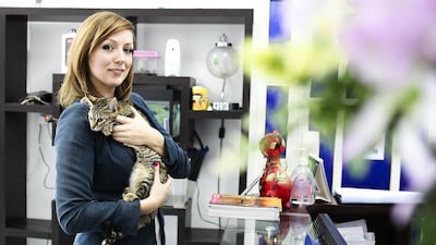 Maria Novik of Fujairah Animal Rescue, which has opened a Facebook group to rescue and care for wounded strays. She is pictured with Tigra, a cat the group rescued. Lee Hoagland / The National