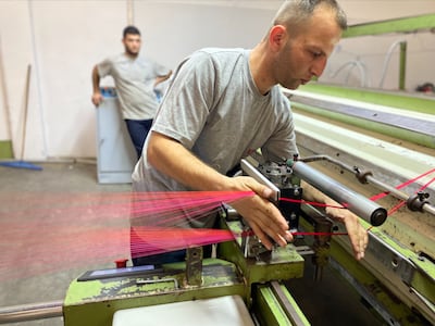 One of the 40 workers at Kutnia's factory in Gaziantep, south-eastern Turkey, prepares threads for manufacture. The few skilled workers left are trying to revive manufacture and pass know-how to the next generation. Lizzie Porter / The National