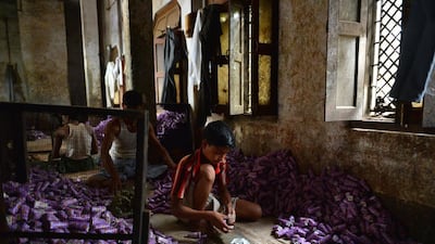 A young labourer packs bidis into colourful conical packets and boxes at The New Sarkar Bidi Factory in Kannauj, some 200kms south-east of New Delhi.