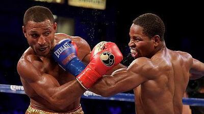 Shawn Porter, right, and Kell Brook trade punches during their IBF welterweight title boxing bout Saturday, Aug. 16, 2014, in Carson, Calif. (AP Photo/Chris Carlson)