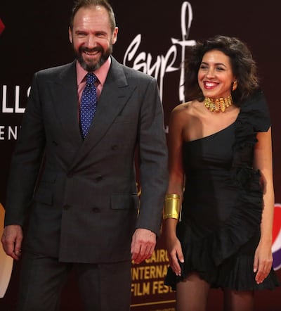 English actor Ralph Fiennes and Egyptian actress and architect Shahira Fahmy walk on the red carpet of the festival. Photo / AFP
