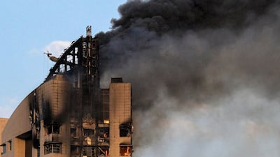 Smoke rises from a high-rise building following a drone attack in Kuwait City on March 8, 2026. AFP