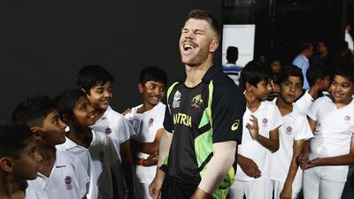 David Warner of Australia speaks with local children during the ICC World Twenty20 Super 10s Group 2 match between Australia and Bangladesh at M. Chinnaswamy Stadium on March 21, 2016 at Bangalore. Ryan Pierse / Getty Images