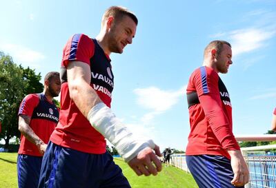 Jamie Vardy and Wayne Rooney make their way onto the pitch during a training session. Getty Images