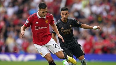 Manchester United's Diogo Dalot, left, challenges for the ball with Arsenal's Gabriel Martinelli. AP Photo