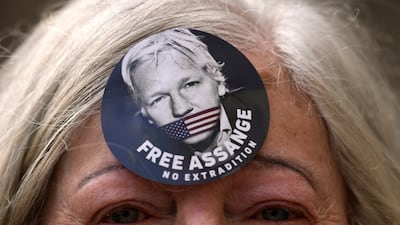 A woman wears a ‘Free Assange’ badge. The US government is scheduled to ask Britain's High Court to overturn a judge's decision that WikiLeaks founder Julian Assange should not be sent to the US to face espionage charges. AP Photo