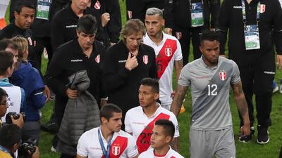 Peru's coach Ricardo Gareca leaves the field with his Peru players after the award ceremony. AP Photo