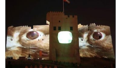 Giant falcons, projected on to the walls of the Fujairah fort, watch over the proceedings of the Al Saif championship for swordsmen. Courtesy Mohammed S AlBloushi
