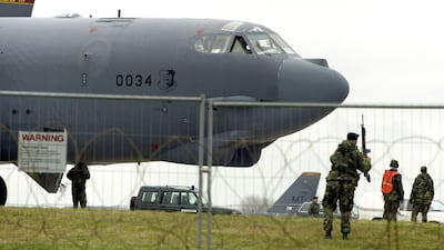 A US serviceman patrols the runway after an American B-52 bomber lands at Fairford Royal Air Force base on March 4, 2003 in Gloucestershire, United Kingdom. Getty Images