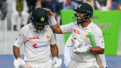 Pakistan batsmen Abdullah Shafique, left, and Imam-ul-Haq leave the field at the tea break. The openers finished Day 5 on 252 without loss as the Test finished in a draw. AFP