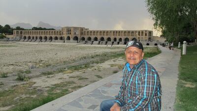 Hamid Khorshidi sits by the dry riverbed of the Zayandehrood in the ancient city of Isfahan in central Iran.