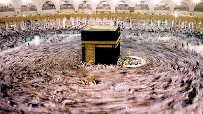 Muslim pilgrims walk around the Kaaba during Umrah. Amr Nabil / AP