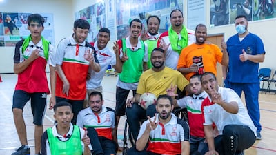 Former Emirati footballer Ahmed Al Akberi, centre, while training the deaf football team at Zayed Higher Organization for People of Determination. He is the first disabled athlete to receive an AFC accreditation to become a sports coach.