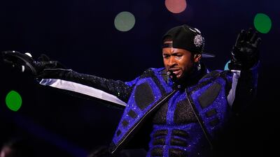 Usher performs during halftime. AP