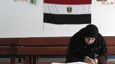 An Egyptian woman votes in the Moqattam district of Cairo. Turnout for parliamentary elections were far higher than expected.