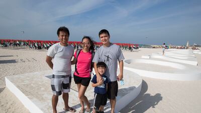 Rolando Ramos with his family at Kite Beach. Ruel Pableo for The National
