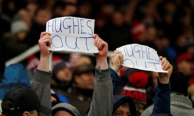 Stoke fans hold up banners calling for manager Mark Hughes to leave the club. Carl Recine / Reuters