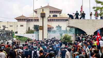Demonstrators carrying Nepal's national flag protest outside the parliament. AFP