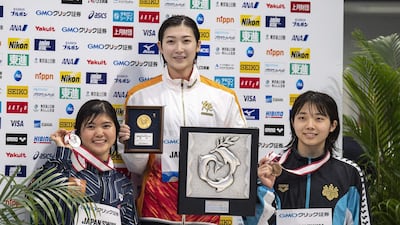 Japanese swimmers, gold medallist Rikako Ikee, centre, silver medallist Suzuka Hasegawa, left, and bronze medallist Chiharu Iitsuka after competing in the 100m butterfly final during the Japan National Swimming Championships. AFP