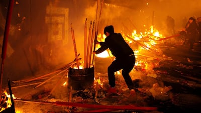 People burn incense sticks and pray for good fortune in Chongqing, China. Reuters