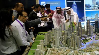 Visitors view a mini-Downtown Dubai featuring Emaar projects during the Cityscape Global 2014. Satish Kumar / The National
