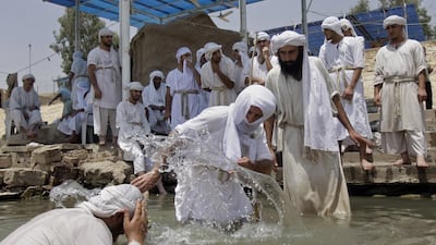 Members of the Sabaean Mandaeans, a pre-Christian sect that follow the teachings of John the Baptist, take part in a bathing ritual on the banks of the Tigris river in Baghdad to mark the new year, which they celebrate as a five day holiday. Khalid Mohammed / AP Photo