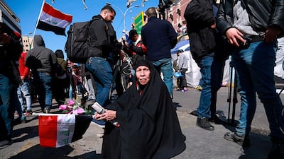 A woman holds a national flag during a protest in Tahrir Square. AP Photo