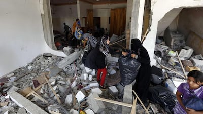 A Palestinian family return to their destroyed home in the northern Gaza Strip city of Beit Hanun. Mohammed Abed / AFP